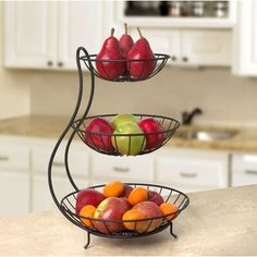 three tiered fruit bowl stand with apples and oranges