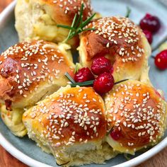 small rolls with cheese and cranberries on a plate