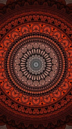 an orange and black circular design on a brown background