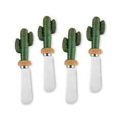 three green cactus plants are in the shape of spoons with cork tops on them