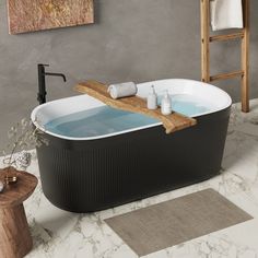 a bathroom with a bathtub and rugs on the floor