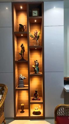 a display case filled with different types of vases and figurines on wooden shelves