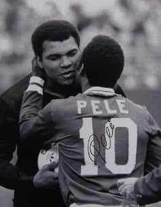 two soccer players hugging each other on the field