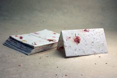 several pieces of paper with red and white flowers on them sitting next to each other