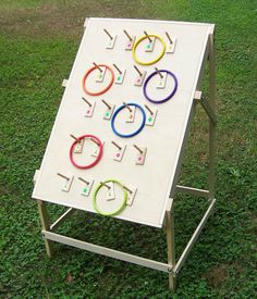 a white board sitting on top of a grass covered field