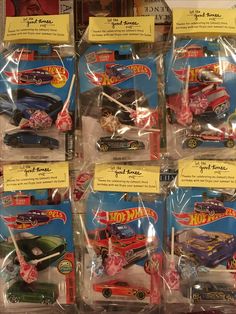 many hot wheels cars are on display in plastic bags with price tags attached to them