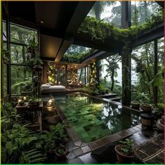 an indoor swimming pool surrounded by greenery and trees in the middle of a forest