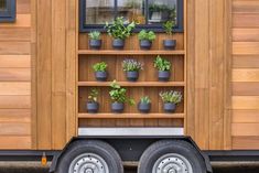 a truck with potted plants on the back of it's cab door and windows