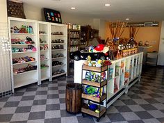 the inside of a toy store filled with lots of shelves and toys on top of checkered flooring