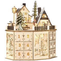 a wooden clock with houses and trees on it