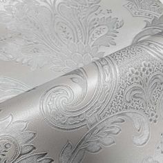 silver wallpaper with an intricate design on the back and sides, as well as metallic foil