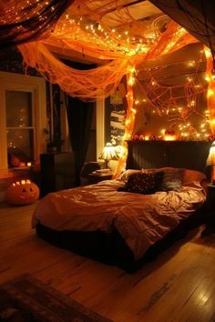 a bedroom decorated for halloween with orange lights