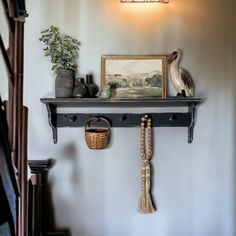 there is a shelf on the wall with some items on it and a lamp above