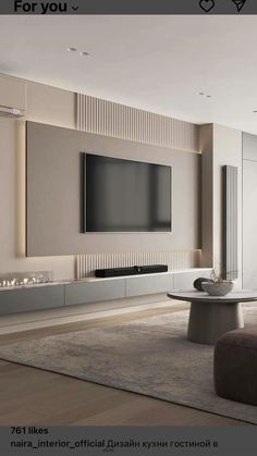 a living room with a large tv on the wall