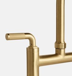 a gold faucet with two handles and nozzles