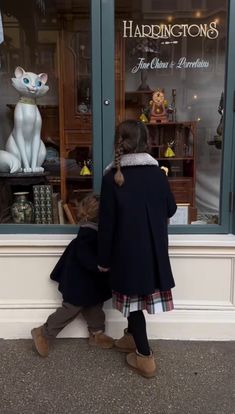 two children in front of a store window