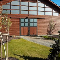 a large wooden building with two doors and windows