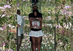 a man and woman standing in front of mirrors