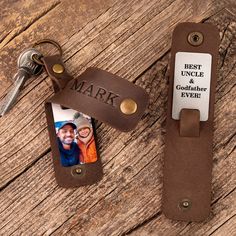 a leather keychain with a personalized photo attached to it and a couple's name tag