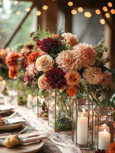 a long table with candles and flowers in vases on top of the tables is set for dinner