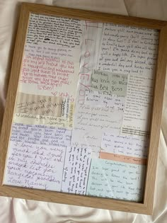 a wooden frame filled with lots of writing on top of a white sheet of paper