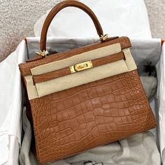 a brown purse sitting inside of a white box