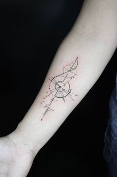 a person's arm with a small tattoo on the left side of their arm