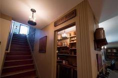 an open door leading to a kitchen with stairs