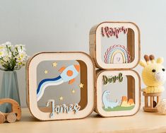 three wooden toys sitting on top of a table