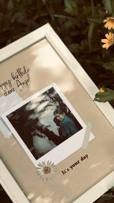 a polaroid frame with an image of a person and flowers