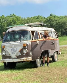 an old van is parked in the grass