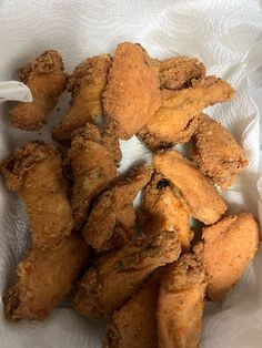 fried chicken sticks in a white paper bag