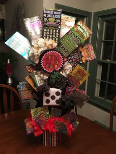 a table topped with lots of cards and dices on top of a wooden table