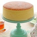 a cake sitting on top of a blue plate next to a cup and saucer