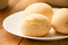 three round bread rolls on a white plate