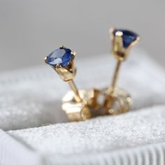 This deep blue Sapphire stud earring is simple & modern, and ideal for men or women. Featuring a tiny (3mm) top quality, genuine blue Sapphire stone in a faceted round cut and a beautiful indigo blue colouring. Set into your choice of either 14k gold fill or sterling silver ear post, it comes with a matching butterfly back. This listing is for one SINGLE stud earring, but you can purchase '2' in Quantity to make a pair and I will be sure to match them up for you. The Sapphire is the birthsto Sapphire Stud Earrings, Blue Sapphire Studs, Aquamarine Studs, Sapphire Stones, Unisex Earrings, Sapphire Earrings Studs, Sapphire Studs, Tiny Stud Earrings, Small Earrings Studs