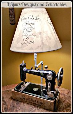 a lamp that is on top of a table with an old sewing machine in front of it