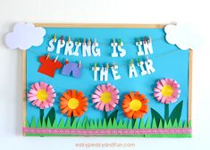 spring is in the air with flowers and clothes pins