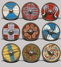 several shields with different designs on them and some metal knobs in the middle one