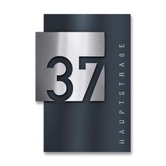 a metal plaque with the number 377 and it's name is displayed on a white background