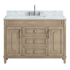 a bathroom vanity with marble top and two faucets on the sink sideboard