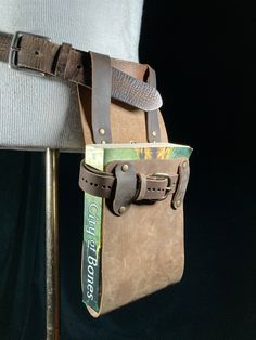 a brown leather bag sitting on top of a chair