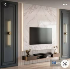 a large tv mounted on the wall in a living room with marble walls and doors