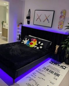 a bed that has been lit up with blue lights and some decorations on the headboard