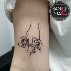 a tattoo on the arm of a person holding something in one hand and pointing it at another