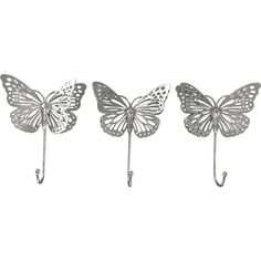 three butterflies are hanging from hooks on the wall