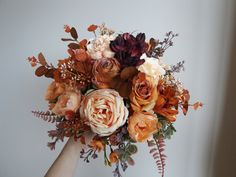 a woman holding a bouquet of flowers in her hand