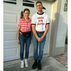 a man and woman standing in front of a garage door