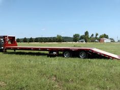 a flatbed trailer parked in the middle of a field