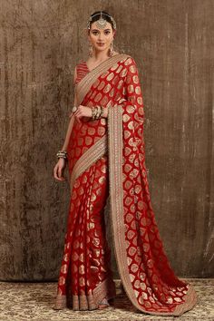 Red georgette woven saree with all ornamental booti placement pattern, border in dabka, sequence and badla work. Paired with silk chanderi V neck blouse with gota work embroidery and crystal tassels detailing on back.
Component: 2
Pattern: Embroidered and Embellished
Type Of Work: Dabka, Sequence, Badla Work and Crystal Tassels
Neckline: V Neck
Sleeve Type: Sleeveless
Fabric: Saree: Georgette, Blouse: Silk Chanderi, Lining: Taffeta Silk
Color: Red
Other Details: 
Blouse: Deep U back with hook an Kasab Embroidery, Polti Bag, Pink Saree Silk, Brocade Saree, Bridal Lehenga Designs, Paisley Motifs, Saree For Women, Embroidered Border, Half Sleeve Blouse